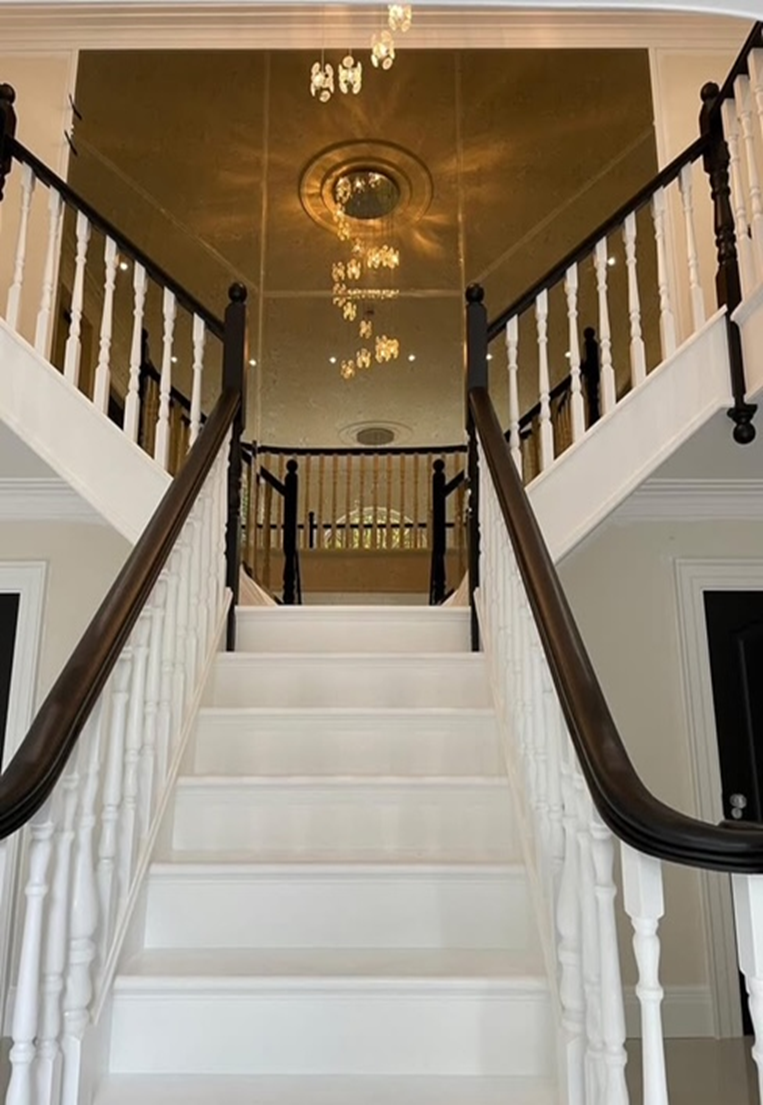 Gold antique mirror staircase feature wall